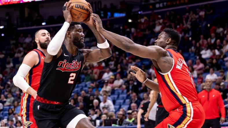 Mar 16, 2024; New Orleans, Louisiana, USA;  Portland Trail Blazers center Deandre Ayton (2) dribbles against New Orleans Pelicans forward Zion Williamson (1) during the first half at Smoothie King Center. Mandatory Credit: Stephen Lew-USA TODAY Sports