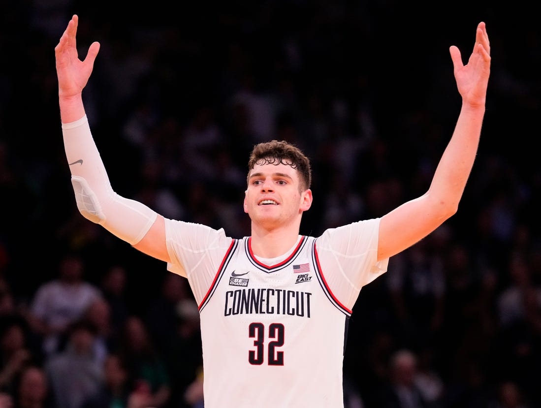 Mar 16, 2024; New York City, NY, USA;  Connecticut Huskies center Donovan Clingan (32) celebrates as the clock winds down against Marquette Golden Eagles in the second half at Madison Square Garden. Mandatory Credit: Robert Deutsch-USA TODAY Sports