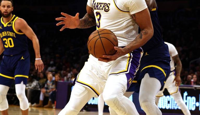 vMar 16, 2024; Los Angeles, California, USA; Los Angeles Lakers forward Anthony Davis (3) spins against Golden State Warriors forward Draymond Green (23) during the first quarter at Crypto.com Arena. Mandatory Credit: Jason Parkhurst-USA TODAY Sports