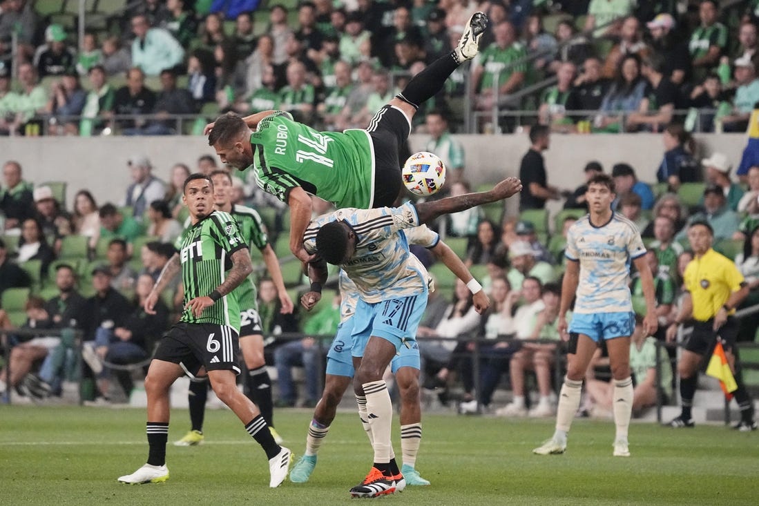 Mar 16, 2024; Austin, Texas, USA; Austin FC forward Diego Rubio (14) and Philadelphia Union defender Damion Lowe (17) collide in the first half at Q2 Stadium. Mandatory Credit: Scott Wachter-USA TODAY Sports