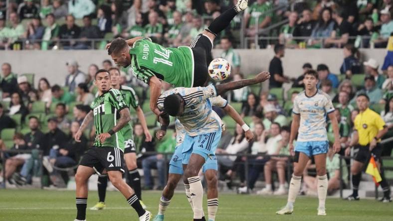 Mar 16, 2024; Austin, Texas, USA; Austin FC forward Diego Rubio (14) and Philadelphia Union defender Damion Lowe (17) collide in the first half at Q2 Stadium. Mandatory Credit: Scott Wachter-USA TODAY Sports