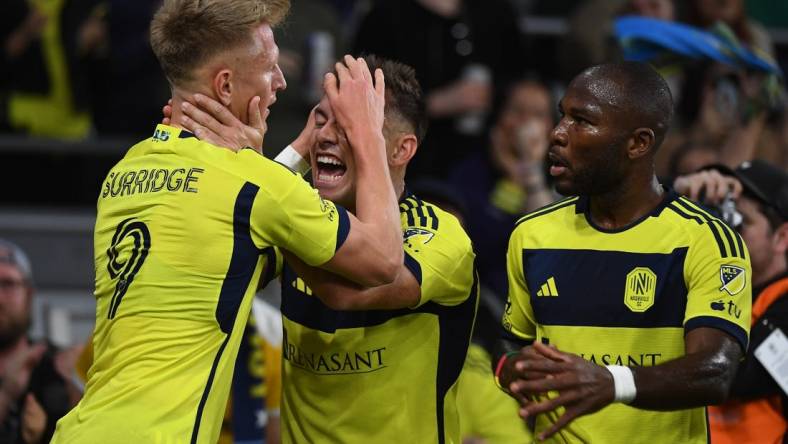 Mar 16, 2024; Nashville, Tennessee, USA; Nashville SC forward Sam Surridge (9) celebrates with defender Taylor Washington (23) after a goal during the first half against Charlotte FC at Geodis Park. Mandatory Credit: Christopher Hanewinckel-USA TODAY Sports