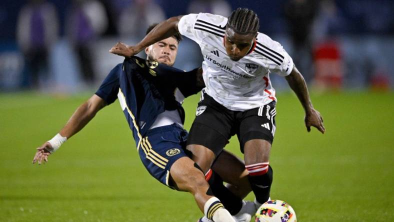 Mar 16, 2024; Frisco, Texas, USA; Vancouver Whitecaps defender Ryan Raposo (7) and FC Dallas forward Dante Sealy (11) battle for control of the ball during the first half at Toyota Stadium. Mandatory Credit: Jerome Miron-USA TODAY Sports