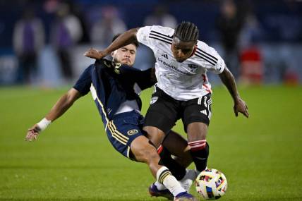 Mar 16, 2024; Frisco, Texas, USA; Vancouver Whitecaps defender Ryan Raposo (7) and FC Dallas forward Dante Sealy (11) battle for control of the ball during the first half at Toyota Stadium. Mandatory Credit: Jerome Miron-USA TODAY Sports