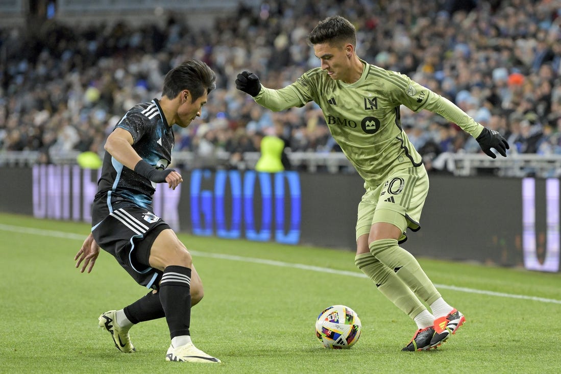 Mar 16, 2024; Saint Paul, Minnesota, USA;  Los Angeles FC midfielder Eduard Atuesta (20) controls the ball as Minnesota United FC forward Jeong Sang-Bin (11) defends during the first half at Allianz Field. Mandatory Credit: Nick Wosika-USA TODAY Sports