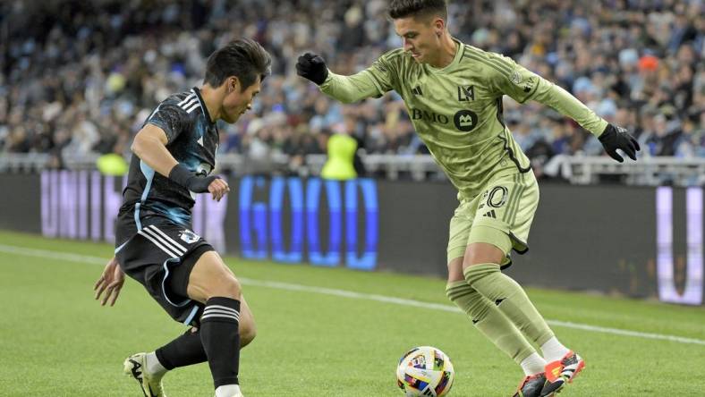 Mar 16, 2024; Saint Paul, Minnesota, USA;  Los Angeles FC midfielder Eduard Atuesta (20) controls the ball as Minnesota United FC forward Jeong Sang-Bin (11) defends during the first half at Allianz Field. Mandatory Credit: Nick Wosika-USA TODAY Sports