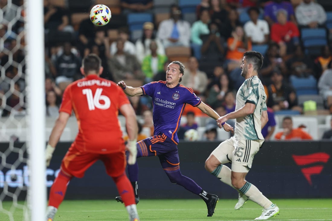 Mar 16, 2024; Houston, Texas, USA; Houston Dynamo FC midfielder Griffin Dorsey (25) runs after the ball against Portland Timbers defender Eric Miller (15) in the first half at Shell Energy Stadium. Mandatory Credit: Troy Taormina-USA TODAY Sports