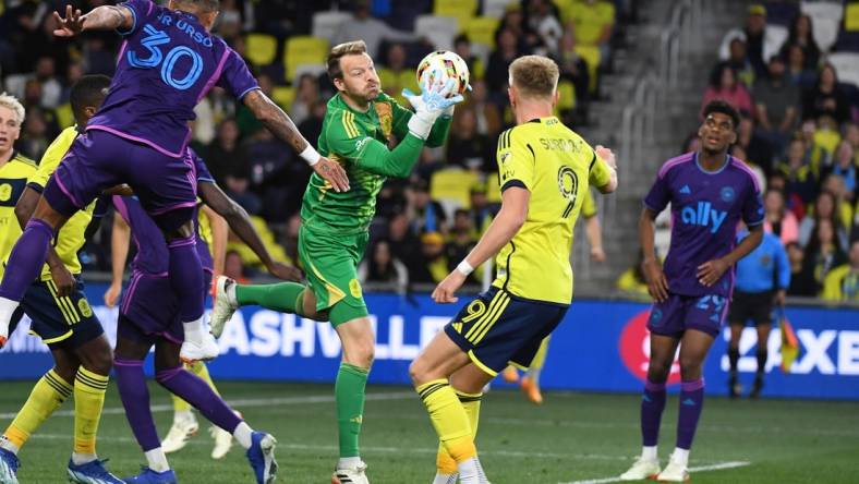 Mar 16, 2024; Nashville, Tennessee, USA; Nashville SC goalkeeper Joe Willis (1) catches the ball on a corner kick during the second half against Charlotte FC at Geodis Park. Mandatory Credit: Christopher Hanewinckel-USA TODAY Sports