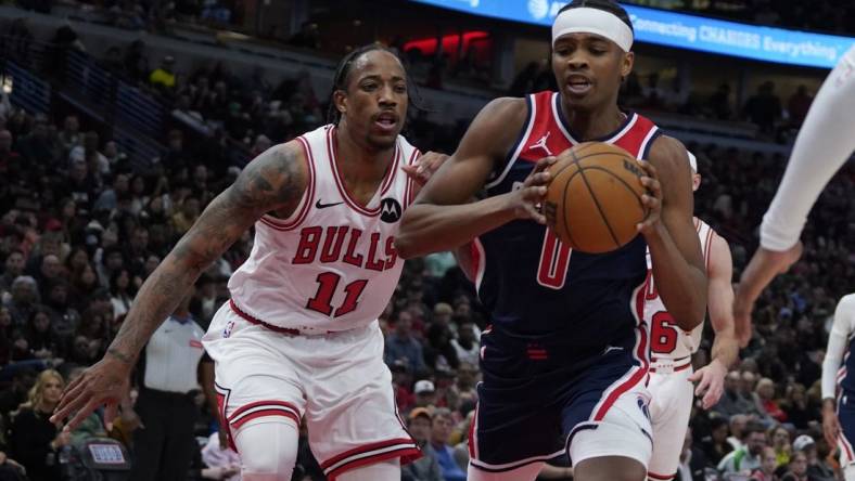 Mar 16, 2024; Chicago, Illinois, USA; Chicago Bulls forward DeMar DeRozan (11) defends Washington Wizards guard Bilal Coulibaly (0) during the second half at United Center. Mandatory Credit: David Banks-USA TODAY Sports