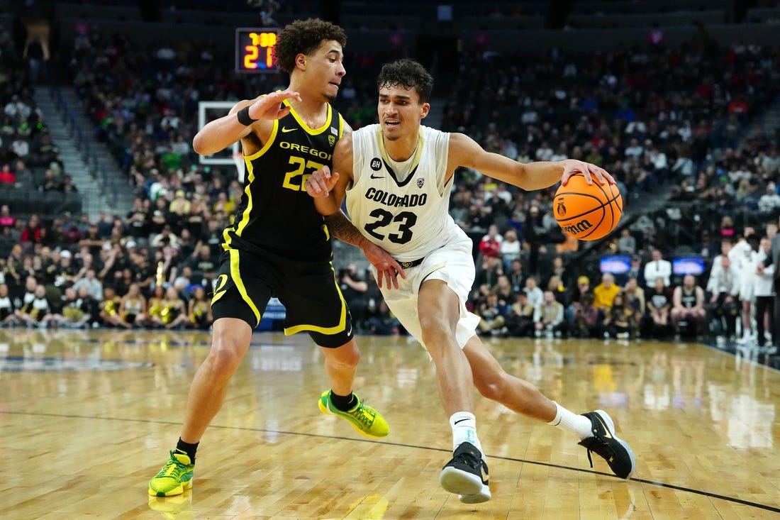 Mar 16, 2024; Las Vegas, NV, USA; Colorado Buffaloes forward Tristan da Silva (23) dribbles against Oregon Ducks guard Jadrian Tracey (22) during the first half at T-Mobile Arena. Mandatory Credit: Stephen R. Sylvanie-USA TODAY Sports