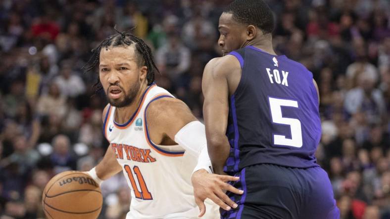 March 16, 2024; Sacramento, California, USA; New York Knicks guard Jalen Brunson (11) dribbles the basketball against Sacramento Kings guard De'Aaron Fox (5) during the second quarter at Golden 1 Center. Mandatory Credit: Kyle Terada-USA TODAY Sports