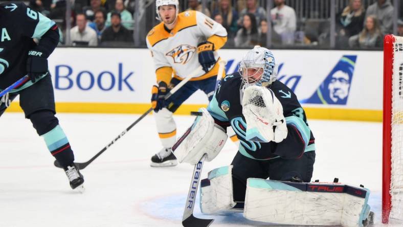 Mar 16, 2024; Seattle, Washington, USA; Seattle Kraken goaltender Philipp Grubauer (31) blocks a goal shot against the Nashville Predators during the first period at Climate Pledge Arena. Mandatory Credit: Steven Bisig-USA TODAY Sports