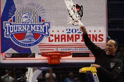 Mar 16, 2024; Washington, D.C., USA; North Carolina State Wolfpack head coach Kevin Keatts reacts by cutting the net from the basketball rim after defeating the North Carolina Tar Heels at Capital One Arena. Mandatory Credit: Geoff Burke-USA TODAY Sports