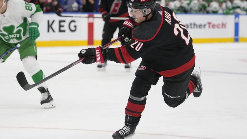 Mar 16, 2024; Toronto, Ontario, CAN; Carolina Hurricanes forward Sebastian Aho (20) shoots the puck against the Toronto Maple Leafs during the second period at Scotiabank Arena. Mandatory Credit: John E. Sokolowski-USA TODAY Sports