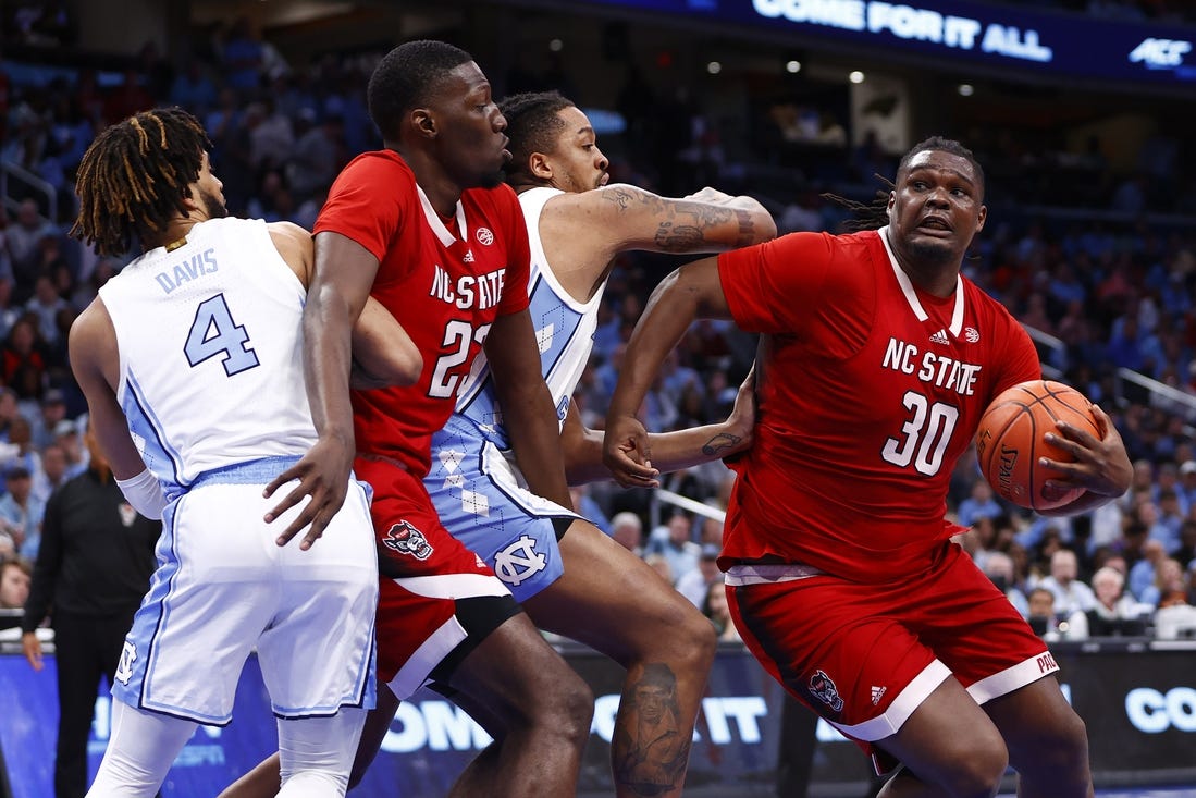 Mar 16, 2024; Washington, D.C., USA; North Carolina State Wolfpack forward DJ Burns Jr. (30) attempts to shoot the ball against the North Carolina Tar Heels during the second half at Capital One Arena. Mandatory Credit: Amber Searls-USA TODAY Sports