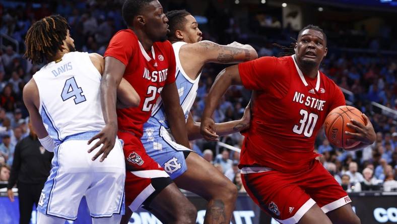 Mar 16, 2024; Washington, D.C., USA; North Carolina State Wolfpack forward DJ Burns Jr. (30) attempts to shoot the ball against the North Carolina Tar Heels during the second half at Capital One Arena. Mandatory Credit: Amber Searls-USA TODAY Sports