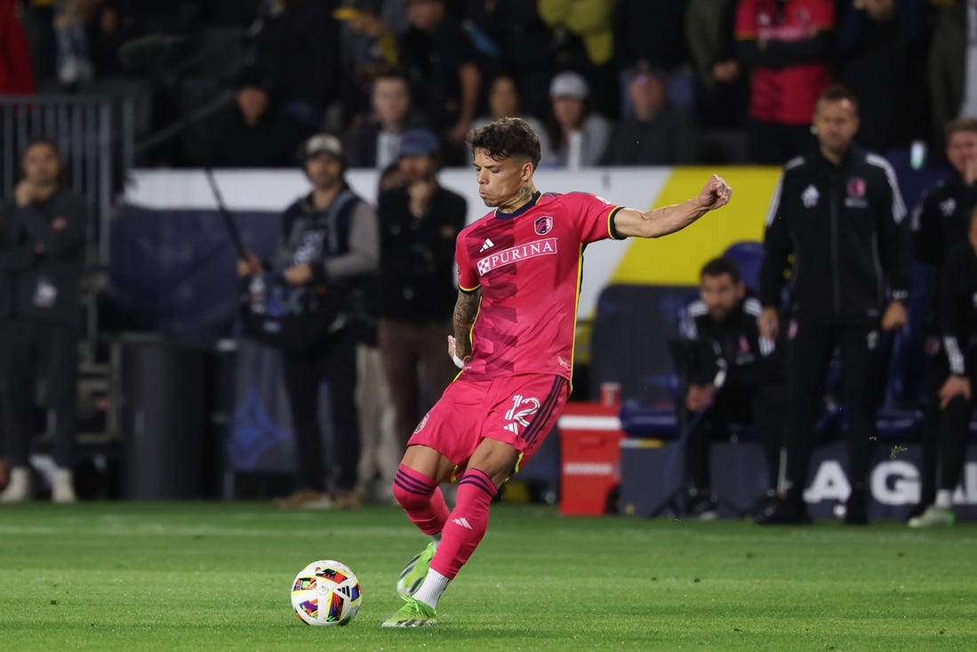 Mar 17, 2024; Carson, California, USA; St. Louis CITY SC midfielder Celio Pompeu (12) takes a free-kick against the LA Galaxy during the second half at Dignity Health Sports Park. Mandatory Credit: Kiyoshi Mio-USA TODAY Sports