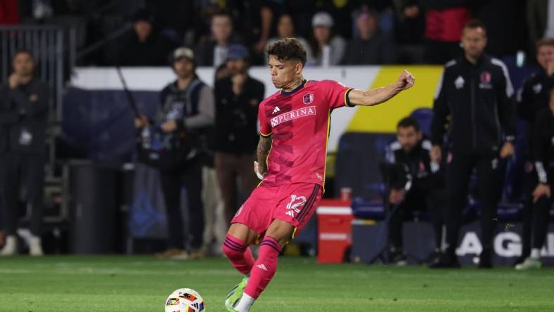 Mar 17, 2024; Carson, California, USA; St. Louis CITY SC midfielder Celio Pompeu (12) takes a free-kick against the LA Galaxy during the second half at Dignity Health Sports Park. Mandatory Credit: Kiyoshi Mio-USA TODAY Sports