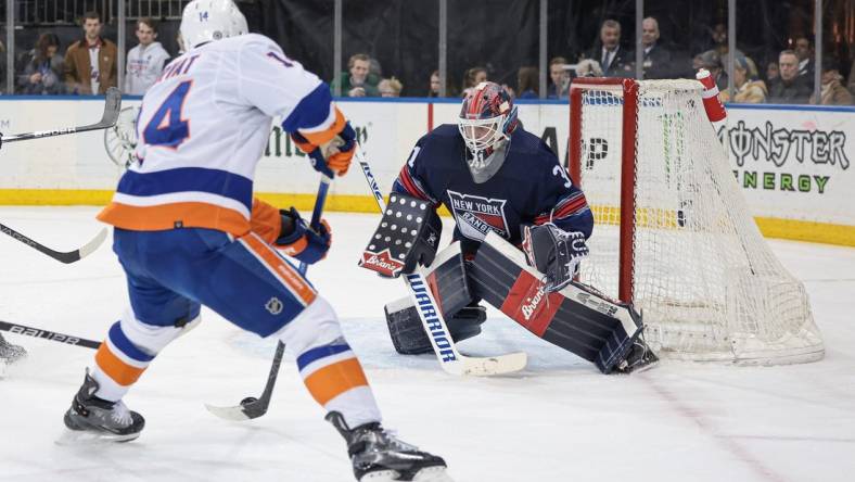 Mar 17, 2024; New York, New York, USA; New York Rangers goaltender Igor Shesterkin (31) defends the goal against New York Islanders center Bo Horvat (14) during the first period at Madison Square Garden. Mandatory Credit: Vincent Carchietta-USA TODAY Sports