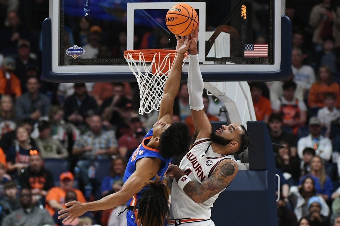 Mar 17, 2024; Nashville, TN, USA; Auburn Tigers forward Johni Broome (4) blocks Florida Gators guard Zyon Pullin (0) in the first half in the SEC Tournament championship game at Bridgestone Arena. Mandatory Credit: Christopher Hanewinckel-USA TODAY Sports