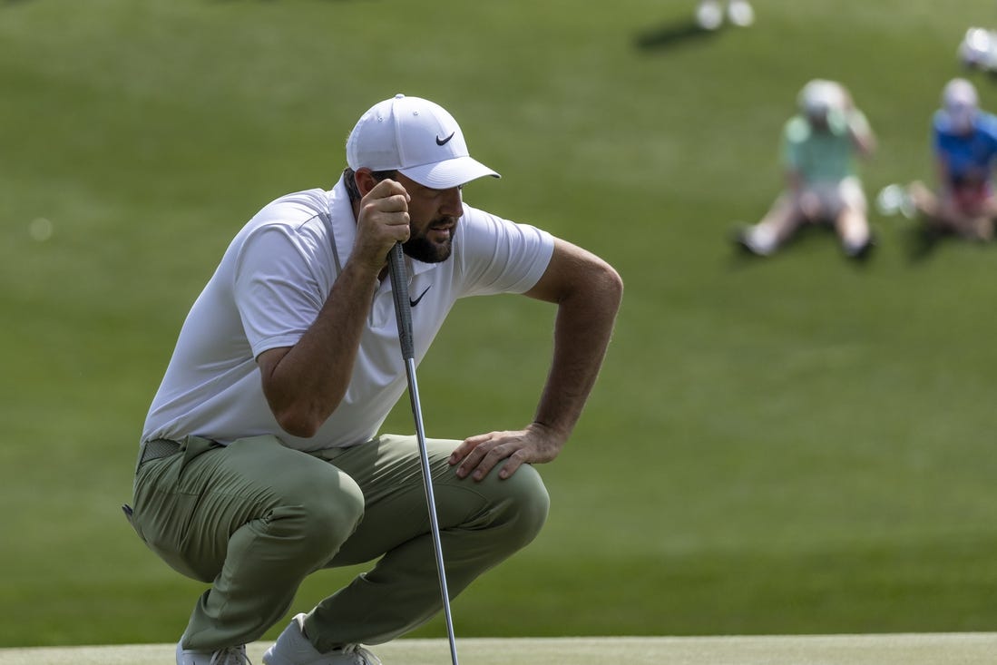 Mar 17, 2024; Ponte Vedra Beach, Florida, USA; Scottie Scheffler lines up a putt on the 3rd green during the final round of THE PLAYERS Championship golf tournament. Mandatory Credit: David Yeazell-USA TODAY Sports