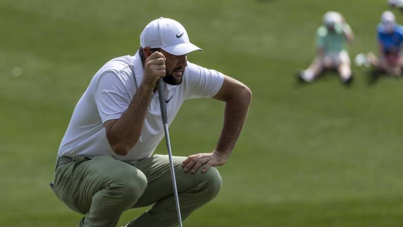 Mar 17, 2024; Ponte Vedra Beach, Florida, USA; Scottie Scheffler lines up a putt on the 3rd green during the final round of THE PLAYERS Championship golf tournament. Mandatory Credit: David Yeazell-USA TODAY Sports