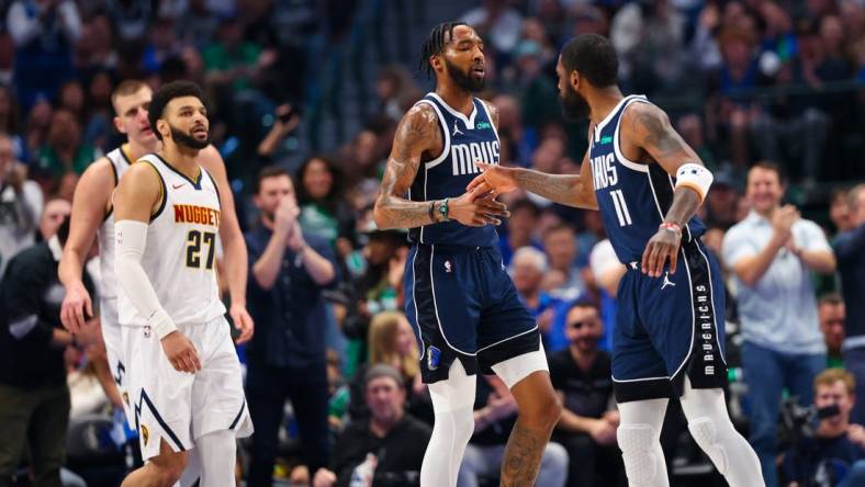 Mar 17, 2024; Dallas, Texas, USA;  Dallas Mavericks forward Derrick Jones Jr. (55) celebrates with Dallas Mavericks guard Kyrie Irving (11) in front of Denver Nuggets guard Jamal Murray (27) during the first quarter at American Airlines Center. Mandatory Credit: Kevin Jairaj-USA TODAY Sports