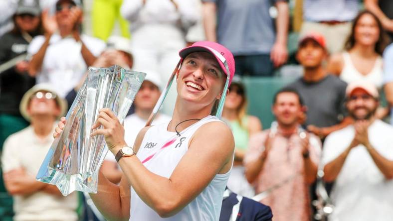 Iga Swiatek holds the BNP Paribas Open championship trophy after defeating Maria Sakkari 6-4, 6-0 at the Indian Wells Tennis Garden in Indian Wells, Calif., on Sunday, March 17, 2024.