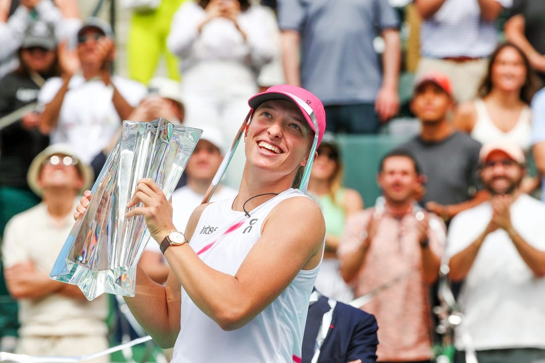 Iga Swiatek holds the BNP Paribas Open championship trophy after defeating Maria Sakkari 6-4, 6-0 at the Indian Wells Tennis Garden in Indian Wells, Calif., on Sunday, March 17, 2024.