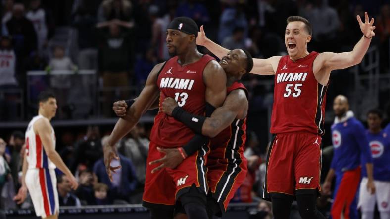 Mar 17, 2024; Detroit, Michigan, USA;  Miami Heat center Bam Adebayo (13) celebrates with guard Terry Rozier (2) and forward Duncan Robinson (55) after he hits a three point basket as time ran out to win the game against the Detroit Pistons at Little Caesars Arena. Mandatory Credit: Rick Osentoski-USA TODAY Sports