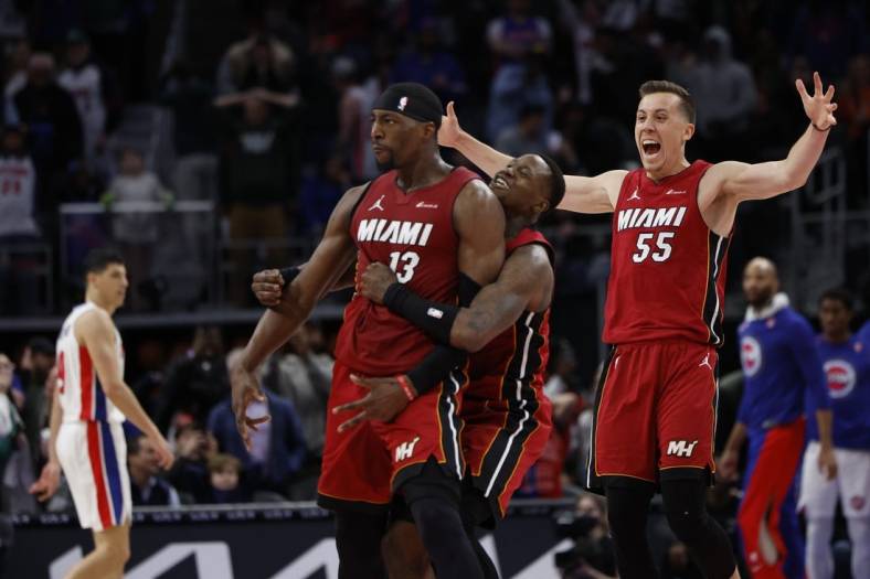 Mar 17, 2024; Detroit, Michigan, USA;  Miami Heat center Bam Adebayo (13) celebrates with guard Terry Rozier (2) and forward Duncan Robinson (55) after he hits a three point basket as time ran out to win the game against the Detroit Pistons at Little Caesars Arena. Mandatory Credit: Rick Osentoski-USA TODAY Sports