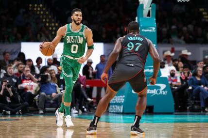 Mar 17, 2024; Washington, District of Columbia, USA; Boston Celtics forward Jayson Tatum (0) brings the ball up court against Washington Wizards forward Eugene Omoruyi (97) during the first half of the game at Capital One Arena. Mandatory Credit: Scott Taetsch-USA TODAY Sports