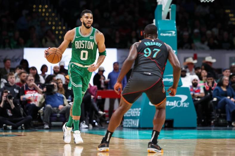 Mar 17, 2024; Washington, District of Columbia, USA; Boston Celtics forward Jayson Tatum (0) brings the ball up court against Washington Wizards forward Eugene Omoruyi (97) during the first half of the game at Capital One Arena. Mandatory Credit: Scott Taetsch-USA TODAY Sports