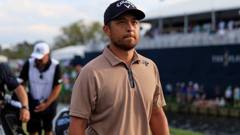 Xander Schauffele walks off hole 18 during the fourth and final round of The Players Championship PGA golf tournament Sunday, March 17, 2024 at TPC Sawgrass in Ponte Vedra Beach, Fla. Scottie Scheffler won at 20 under par and is the first defending champion in the 50 year history of the event. [Corey Perrine/Florida Times-Union]