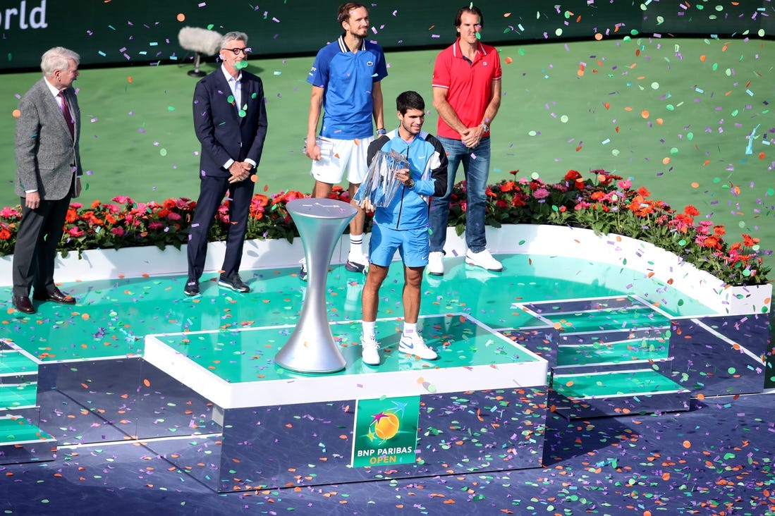 Carlos Alcaraz holds the trophy after defeating Daniil Medvedev 7-6(5), 6-1in the BNP Paribas Open championship match at the Indian Wells Tennis Garden in Indian Wells, Calif., on Sunday, March 17, 2024.