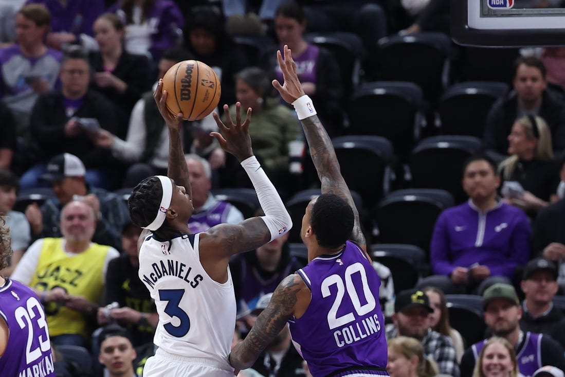 Mar 18, 2024; Salt Lake City, Utah, USA; Minnesota Timberwolves forward Jaden McDaniels (3) goes to the basket against Utah Jazz forward John Collins (20) during the first quarter at Delta Center. Mandatory Credit: Rob Gray-USA TODAY Sports