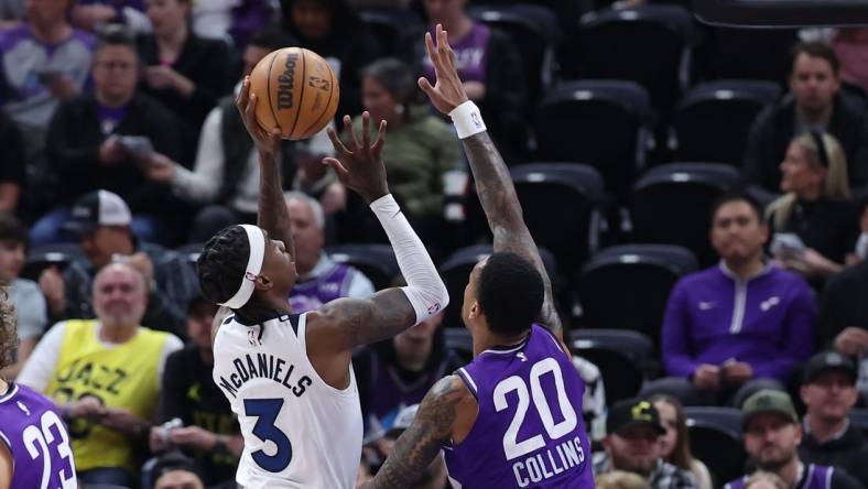 Mar 18, 2024; Salt Lake City, Utah, USA; Minnesota Timberwolves forward Jaden McDaniels (3) goes to the basket against Utah Jazz forward John Collins (20) during the first quarter at Delta Center. Mandatory Credit: Rob Gray-USA TODAY Sports