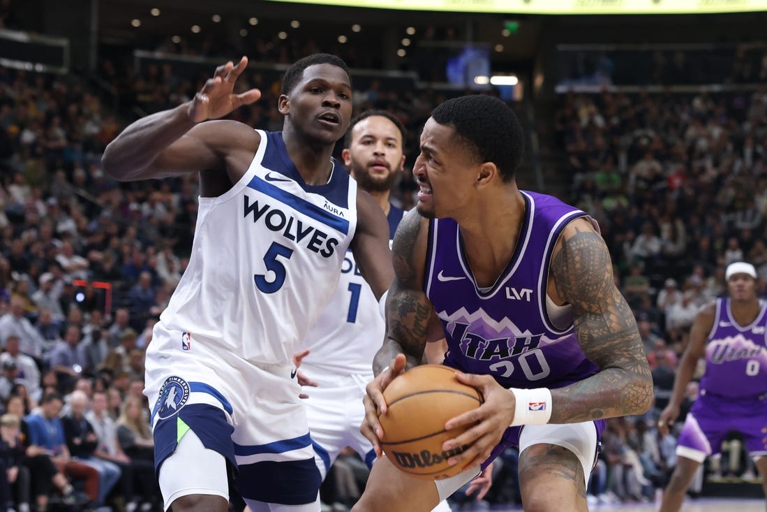 Mar 18, 2024; Salt Lake City, Utah, USA; Utah Jazz forward John Collins (20) goes to the basket against Minnesota Timberwolves guard Anthony Edwards (5) during the second quarter at Delta Center. Mandatory Credit: Rob Gray-USA TODAY Sports