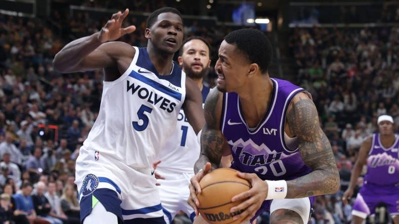 Mar 18, 2024; Salt Lake City, Utah, USA; Utah Jazz forward John Collins (20) goes to the basket against Minnesota Timberwolves guard Anthony Edwards (5) during the second quarter at Delta Center. Mandatory Credit: Rob Gray-USA TODAY Sports