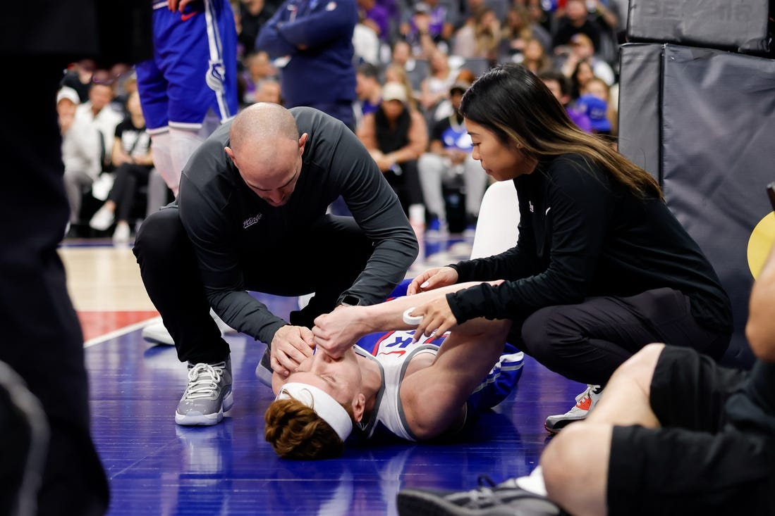 Mar 18, 2024; Sacramento, California, USA; Sacramento Kings guard Kevin Huerter (9) suffers an injury during the first quarter against the Memphis Grizzlies at Golden 1 Center. Mandatory Credit: Sergio Estrada-USA TODAY Sports