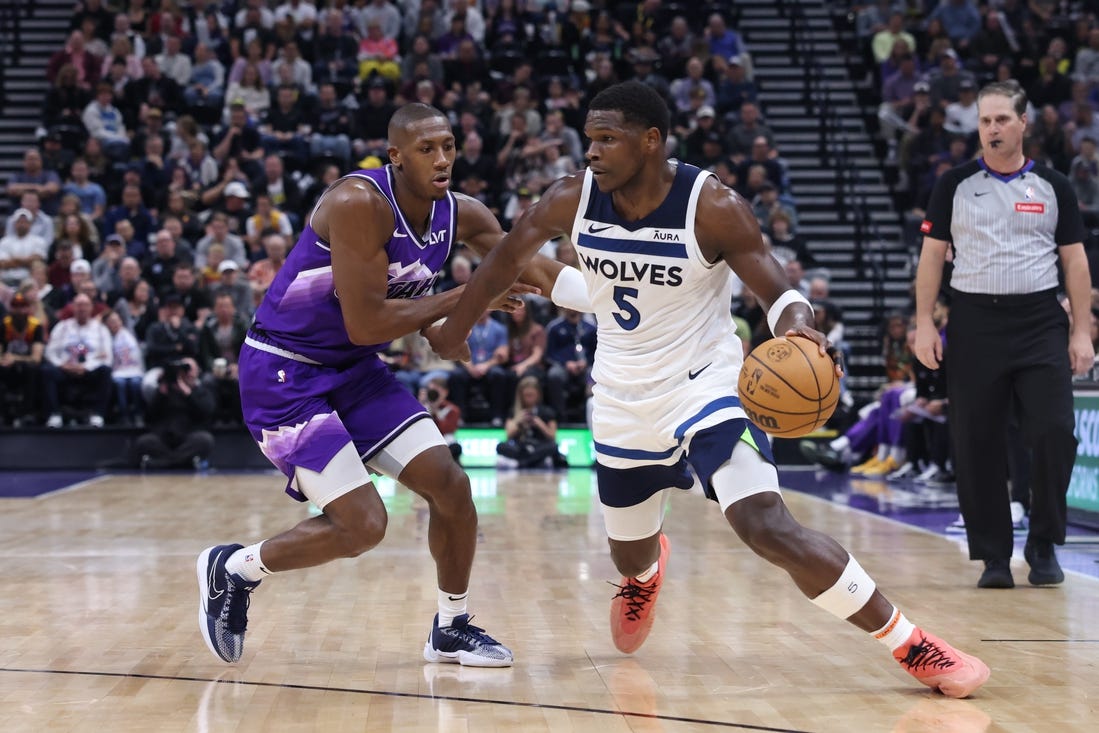 Mar 18, 2024; Salt Lake City, Utah, USA; Minnesota Timberwolves guard Anthony Edwards (5) drives against Utah Jazz guard Kris Dunn (11) during the third quarter at Delta Center. Mandatory Credit: Rob Gray-USA TODAY Sports