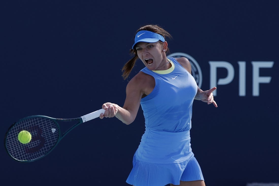 Mar 19, 2024; Miami Gardens, FL, USA; Simona Halep (ROU) hits a forehand against Paula Badosa (ESP) (not pictured) on day two of the Miami Open at Hard Rock Stadium. Mandatory Credit: Geoff Burke-USA TODAY Sports