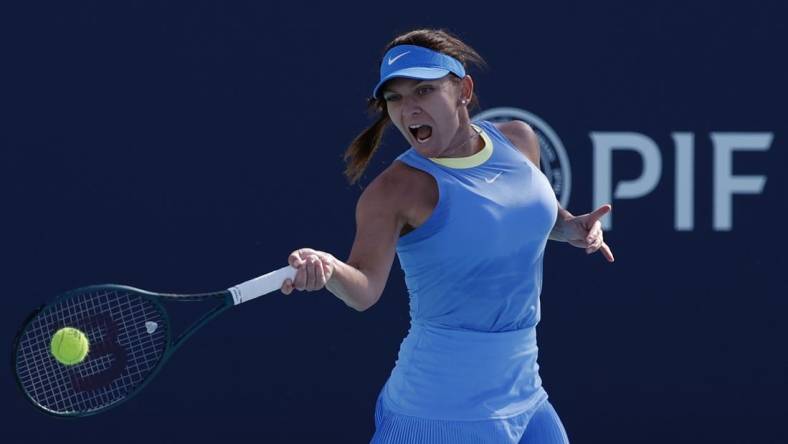 Mar 19, 2024; Miami Gardens, FL, USA; Simona Halep (ROU) hits a forehand against Paula Badosa (ESP) (not pictured) on day two of the Miami Open at Hard Rock Stadium. Mandatory Credit: Geoff Burke-USA TODAY Sports