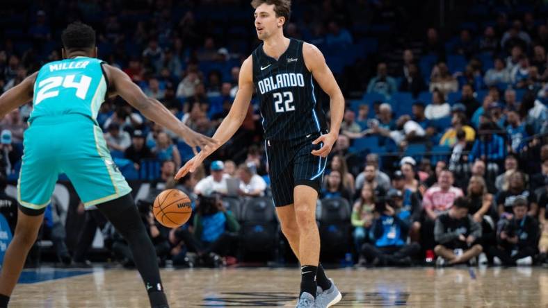 Mar 19, 2024; Orlando, Florida, USA; Orlando Magic forward Franz Wagner (22) dribbles the ball against Charlotte Hornets forward Brandon Miller (24) in the first quarter at KIA Center. Mandatory Credit: Jeremy Reper-USA TODAY Sports