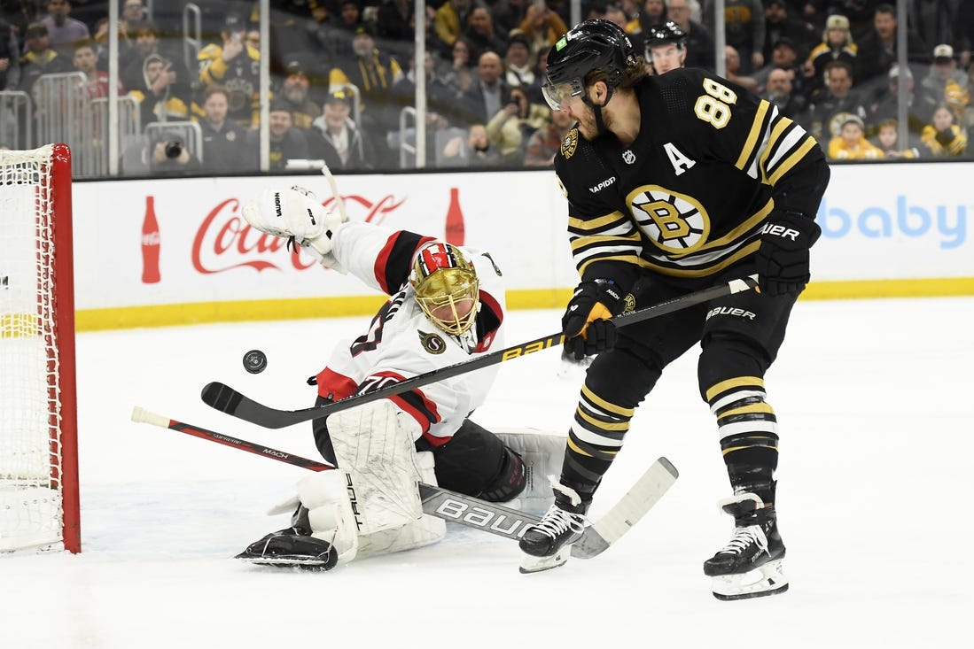 Mar 19, 2024; Boston, Massachusetts, USA;  Boston Bruins right wing David Pastrnak (88) scores a goal past Ottawa Senators goaltender Joonas Korpisalo (70) during the first period at TD Garden. Mandatory Credit: Bob DeChiara-USA TODAY Sports