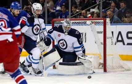 Mar 19, 2024; New York, New York, USA; Winnipeg Jets goalie Connor Hellebuyck (37) makes a save against the New York Rangers during the first period at Madison Square Garden. Mandatory Credit: Danny Wild-USA TODAY Sports