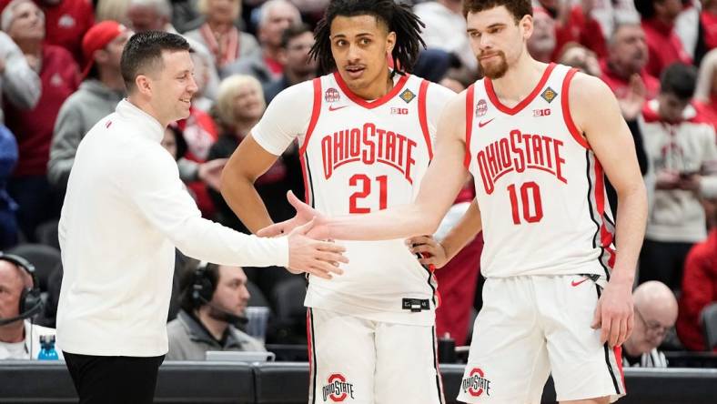 Mar 19, 2024; Columbus, OH, USA; Ohio State Buckeyes head coach Jake Diebler high fives Ohio State Buckeyes forward Jamison Battle (10) and forward Devin Royal (21) during the second half of the NIT basketball game against the Cornell Big Red at Value City Arena. Ohio State won 88-83.