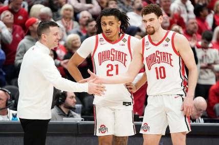 Mar 19, 2024; Columbus, OH, USA; Ohio State Buckeyes head coach Jake Diebler high fives Ohio State Buckeyes forward Jamison Battle (10) and forward Devin Royal (21) during the second half of the NIT basketball game against the Cornell Big Red at Value City Arena. Ohio State won 88-83.
