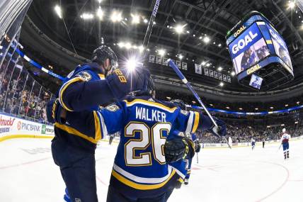 Mar 19, 2024; St. Louis, Missouri, USA;  St. Louis Blues right wing Alexey Toropchenko (13) celebrates with left wing Nathan Walker (26) after scoring against the Colorado Avalanche during the second period at Enterprise Center. Mandatory Credit: Jeff Curry-USA TODAY Sports