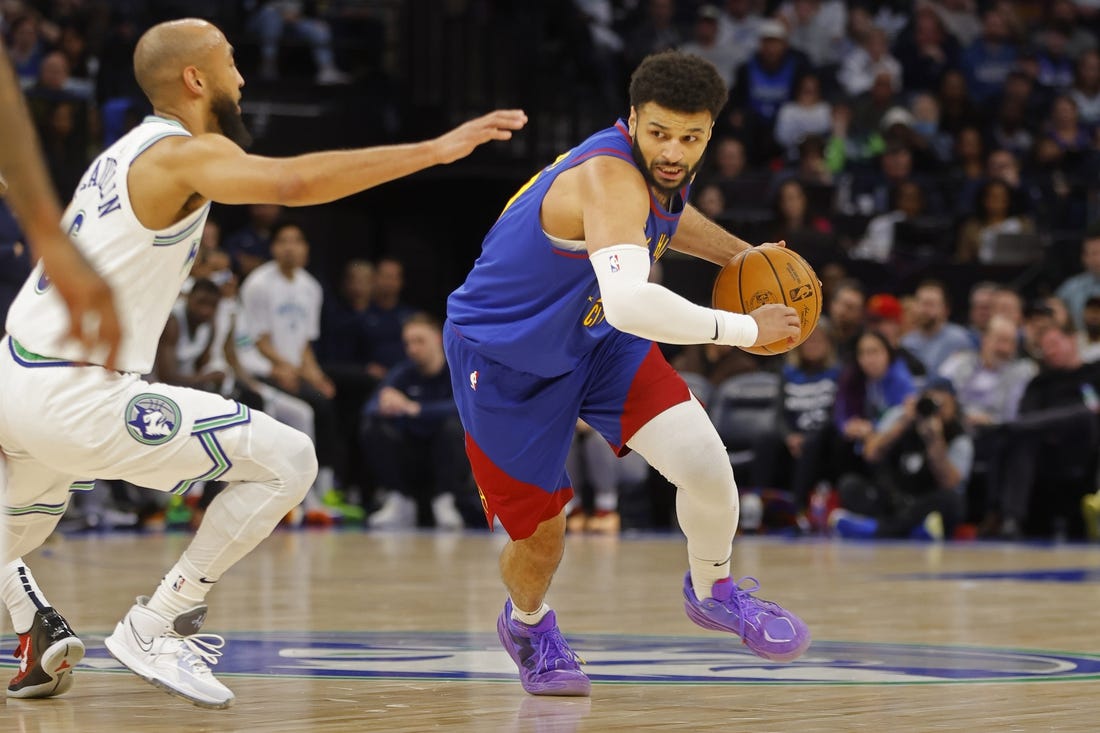 Mar 19, 2024; Minneapolis, Minnesota, USA; Denver Nuggets guard Jamal Murray (27) works around Minnesota Timberwolves guard Jordan McLaughlin (6) in the second quarter at Target Center. Mandatory Credit: Bruce Kluckhohn-USA TODAY Sports